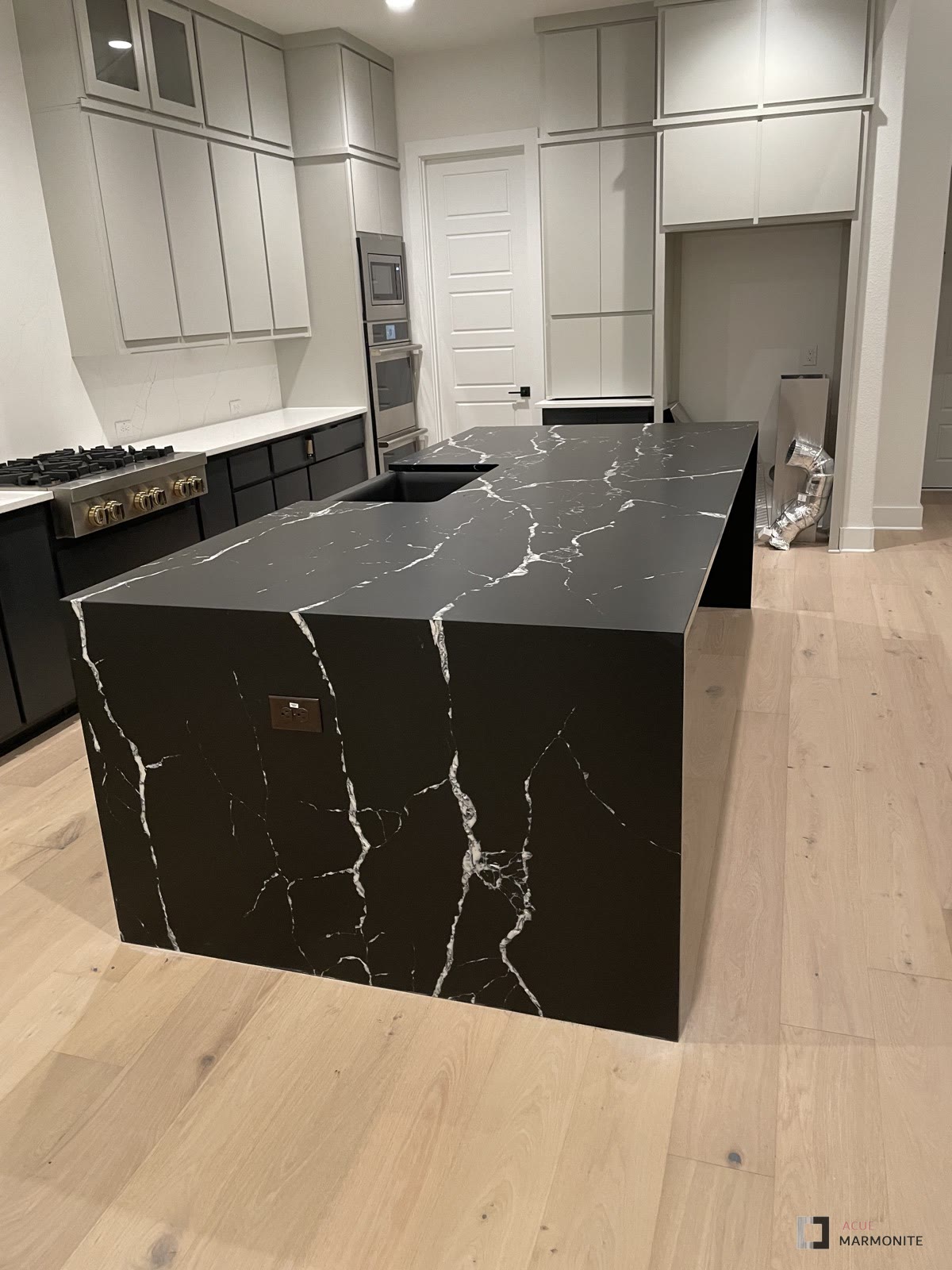 Waterfall-edge quartz countertop installed by Acue Marmonite